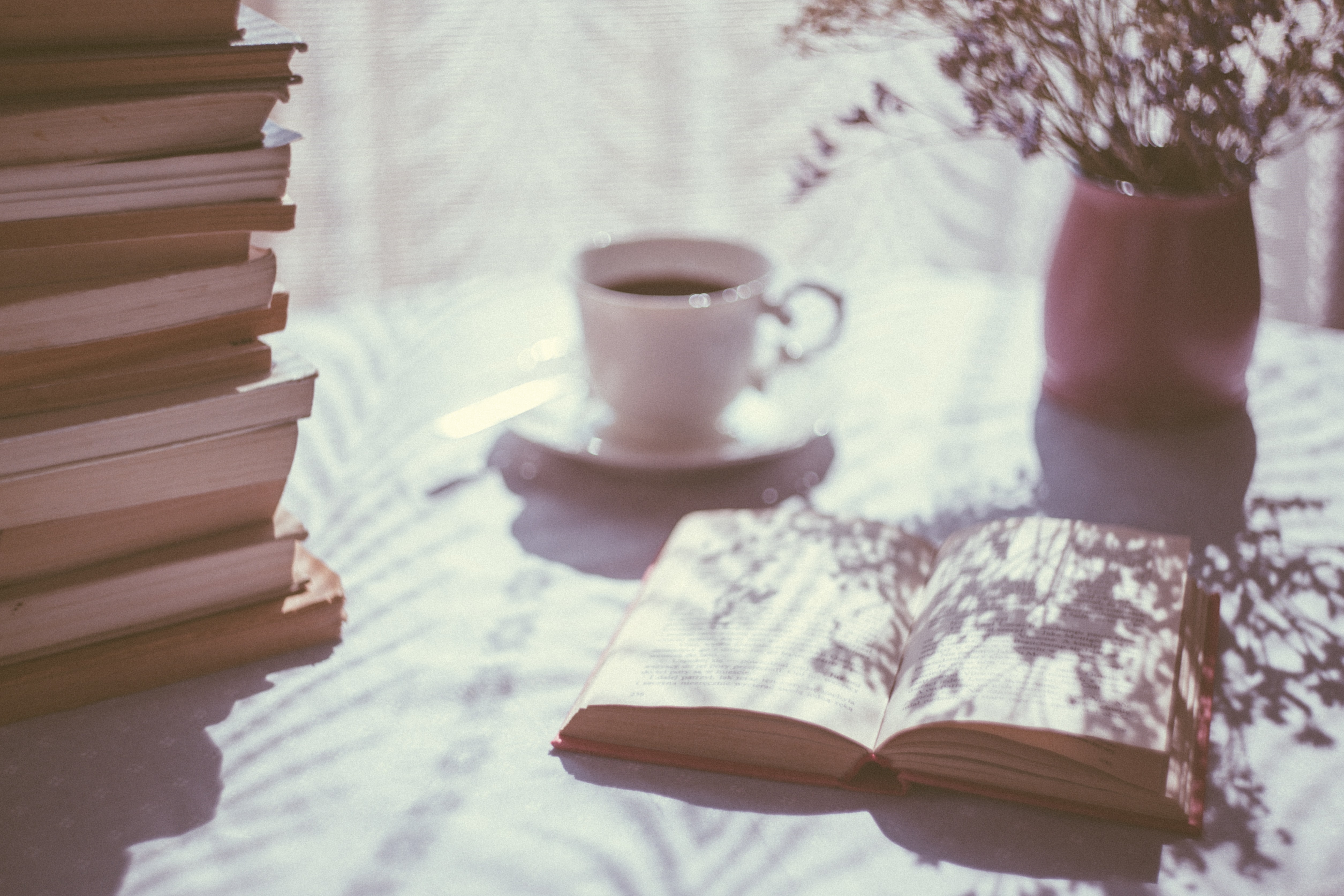 teacup and book on table by freestocks