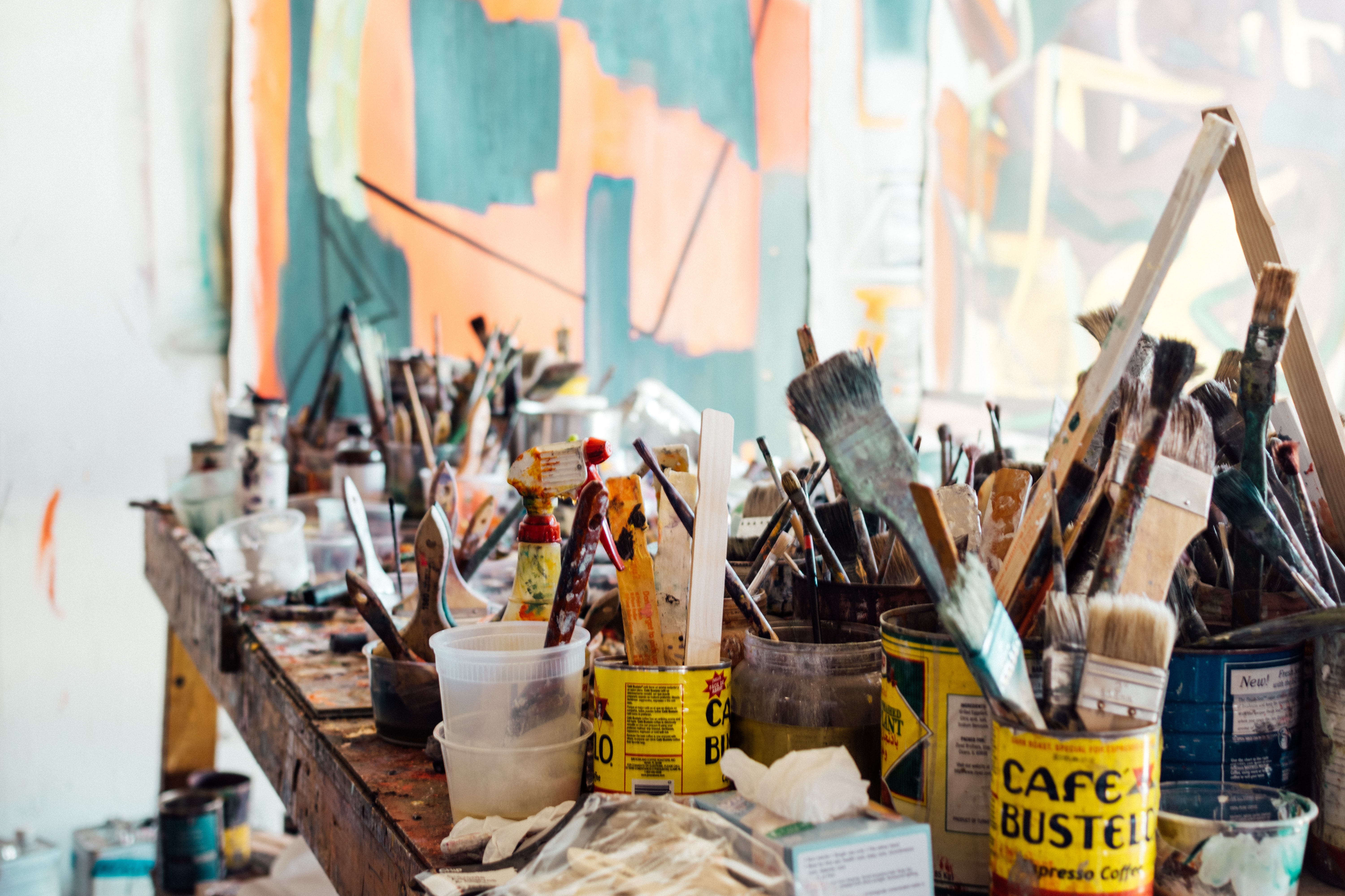 it is an image of paints and paint brushes on a table