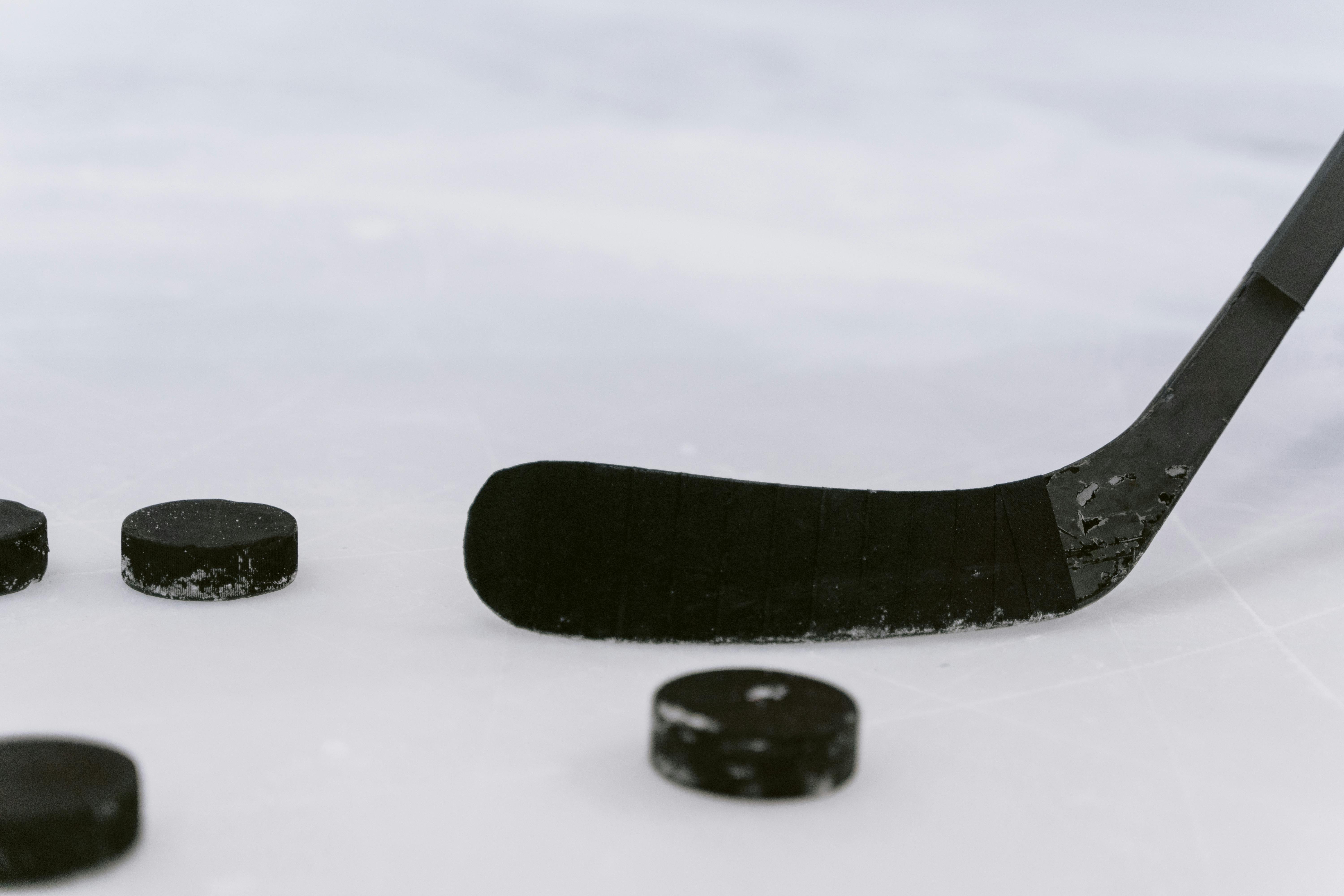 hockey stick and hockey pucks