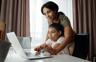 Woman and her daughter looking at a computer.
