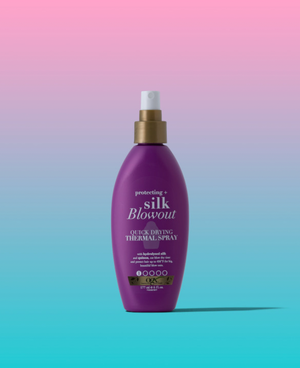 Bottle of hair product in front of an ombre pink and blue background