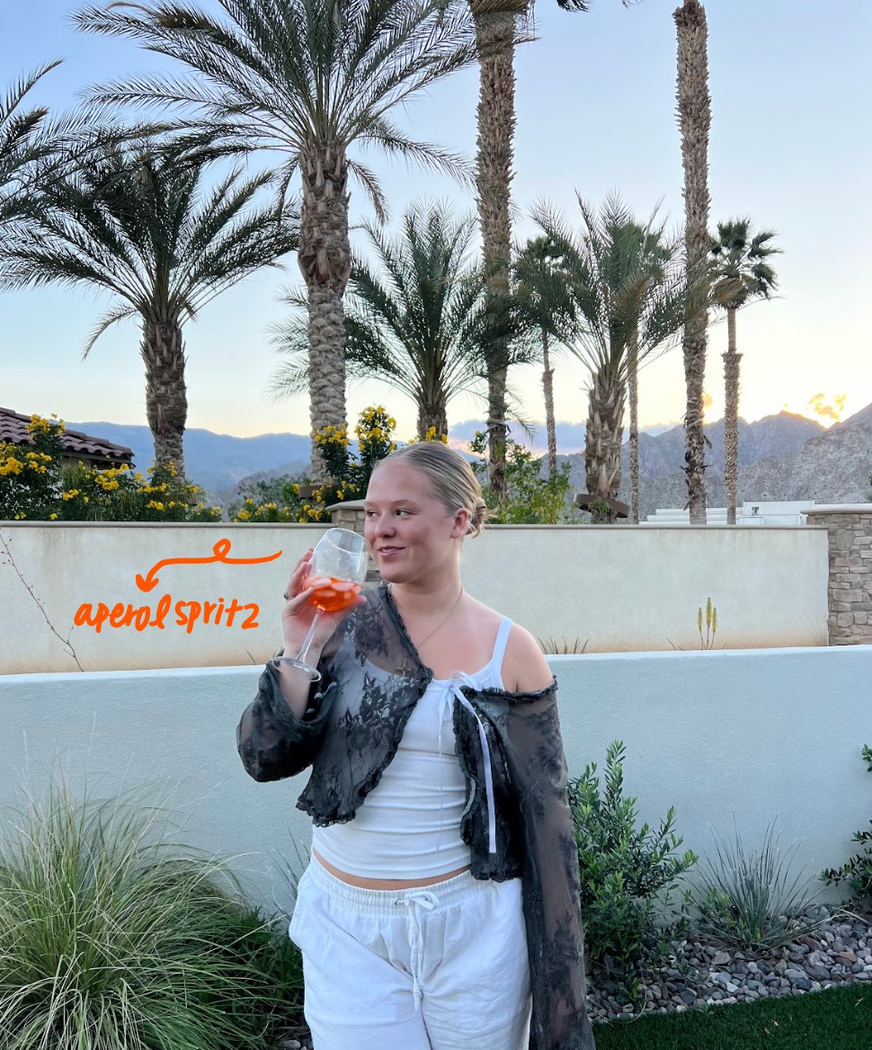 girl drinking an aperol spritz
