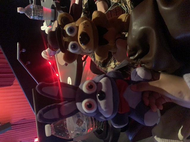a fnaf freddy plushie and bonnie plushie at a theater