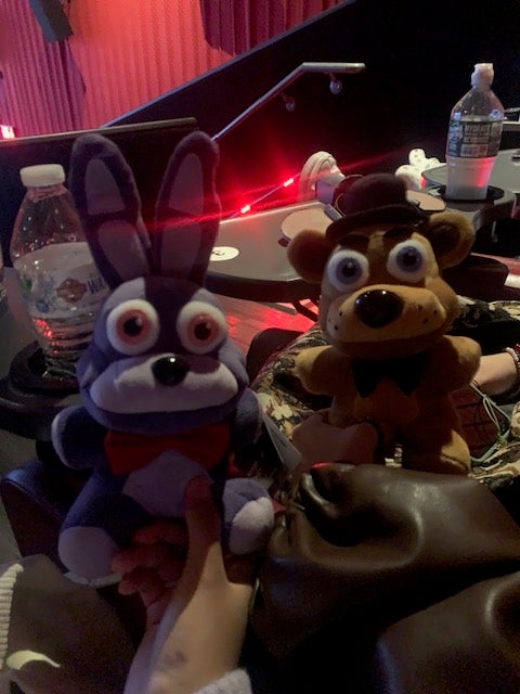 a fnaf freddy plushie and bonnie plushie at a theater