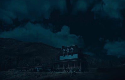 a ranch house with its lights off at night