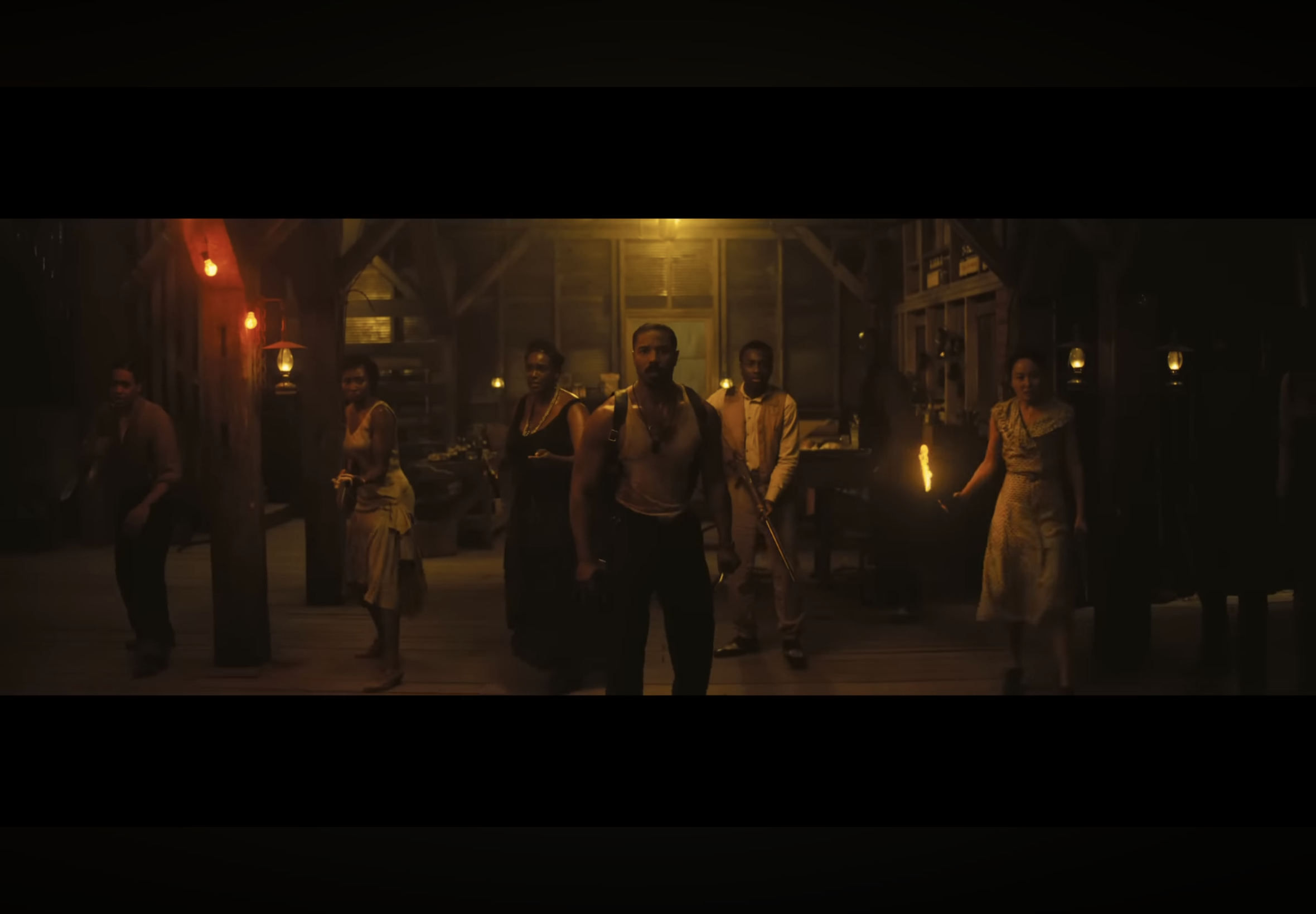 Six of the main characters from the movie Sinners standing in a line getting ready to fight