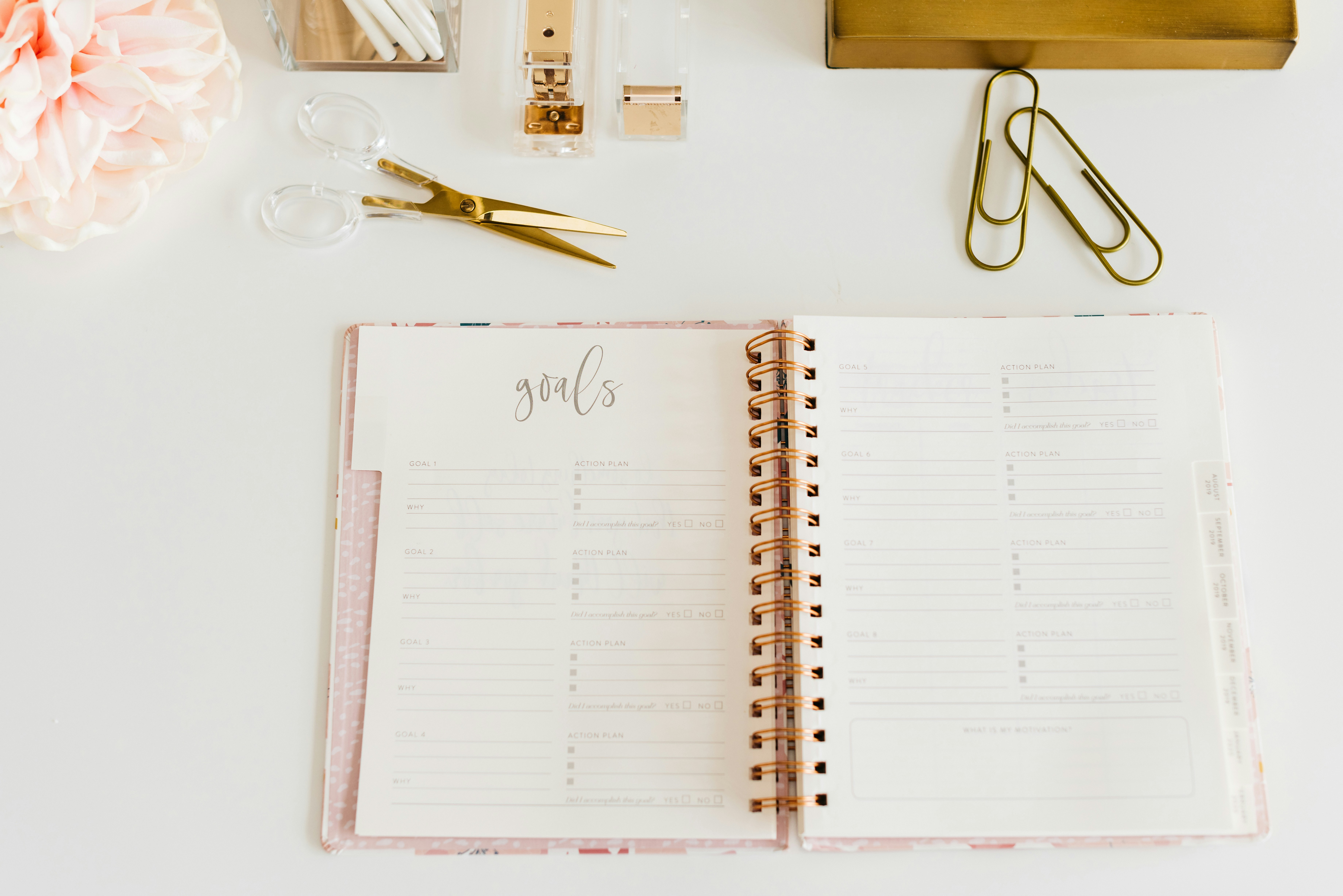 pink planner and desk items