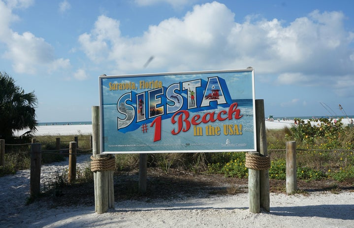 Sign on a beach saying \"Siesta #1 Beach\"