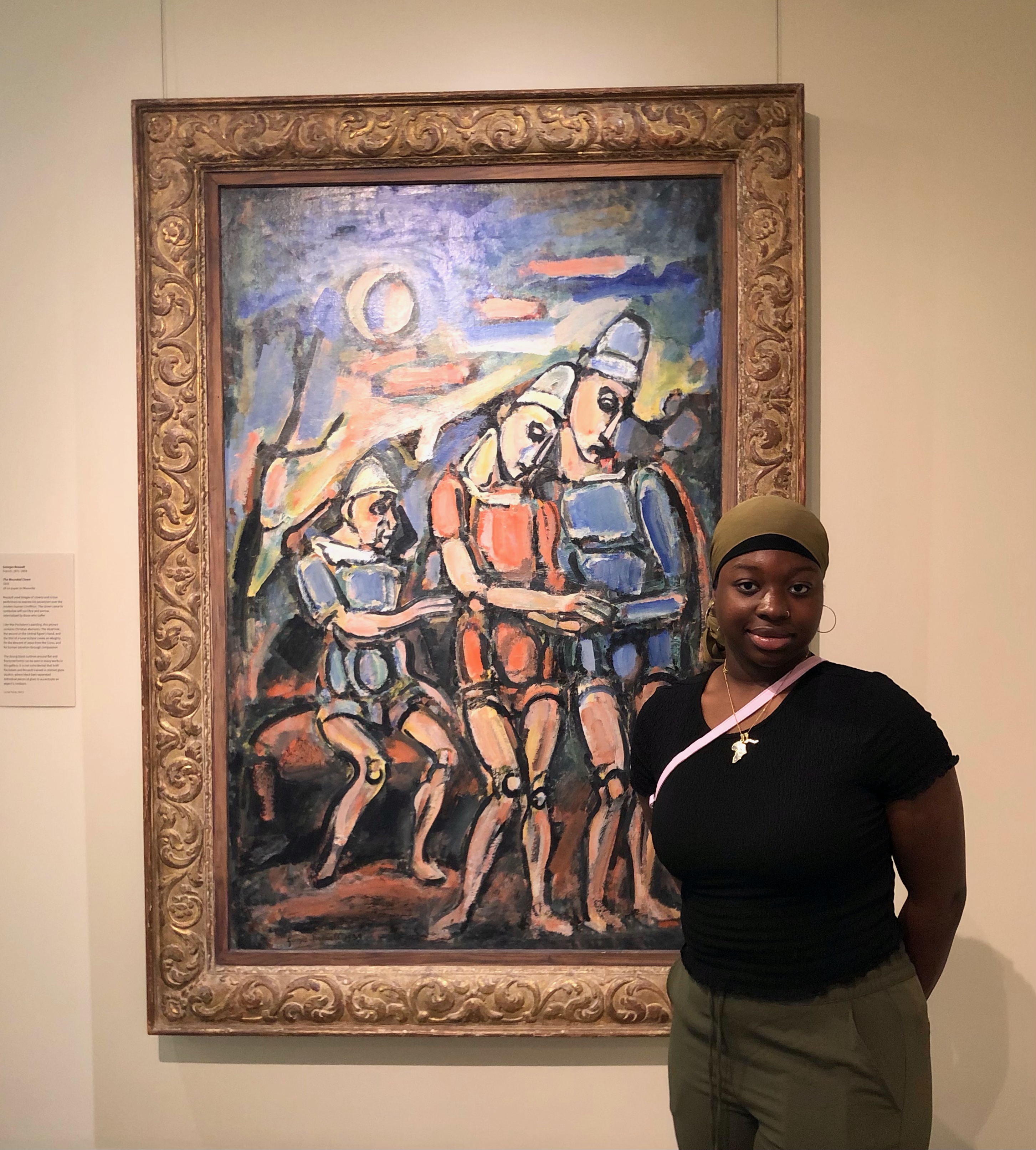 Mariam Hydara standing in front of a painting