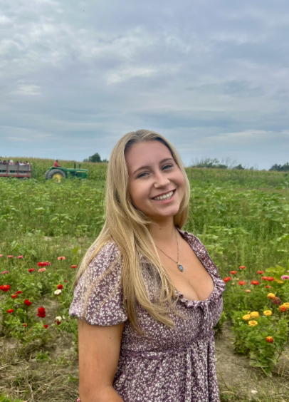 headshot of an IC alumni in a field of flowers