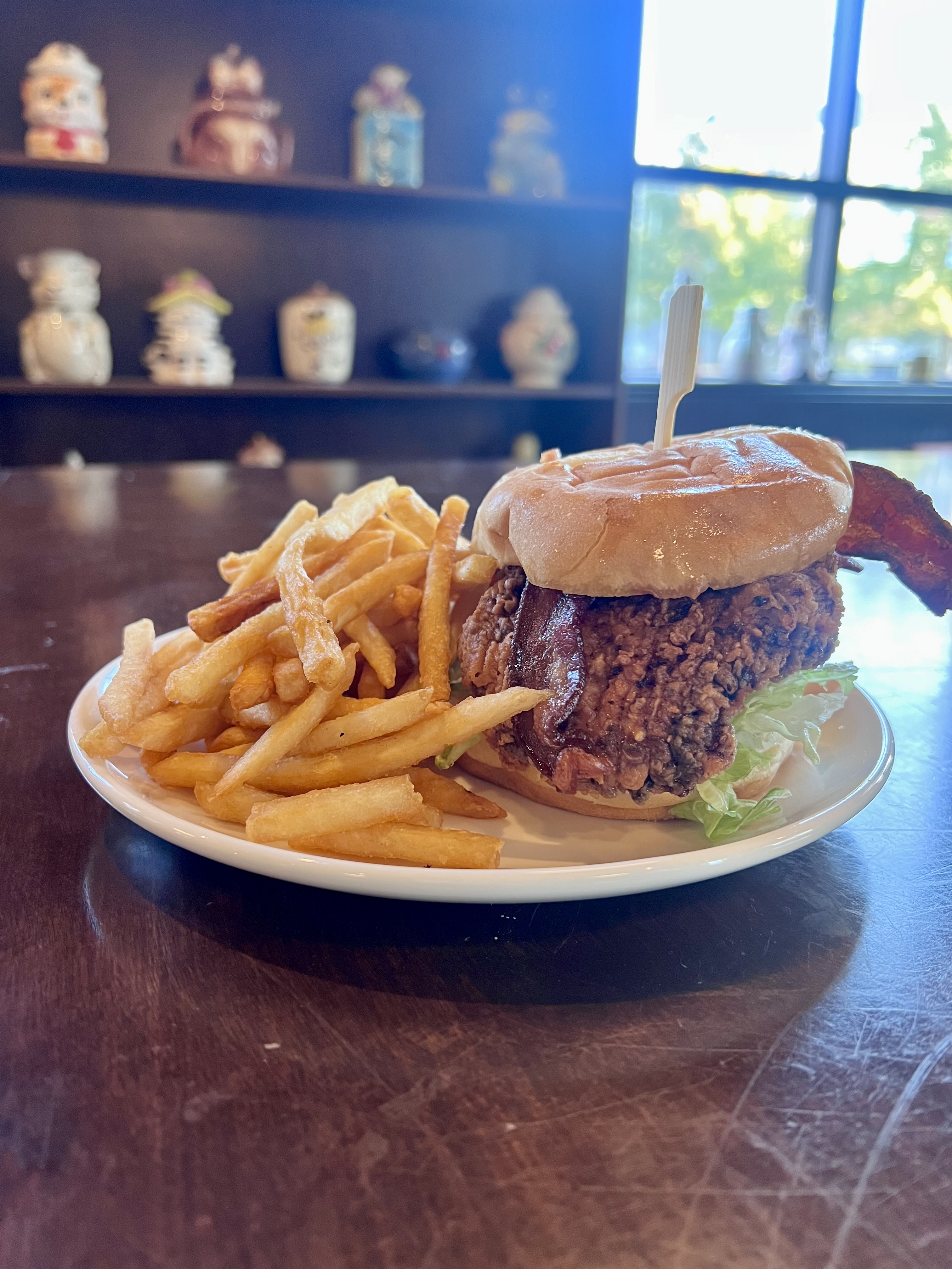 Fried chicken sandwich with plate of fries