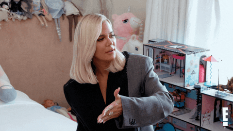 Khloe Kardashian waving hand around