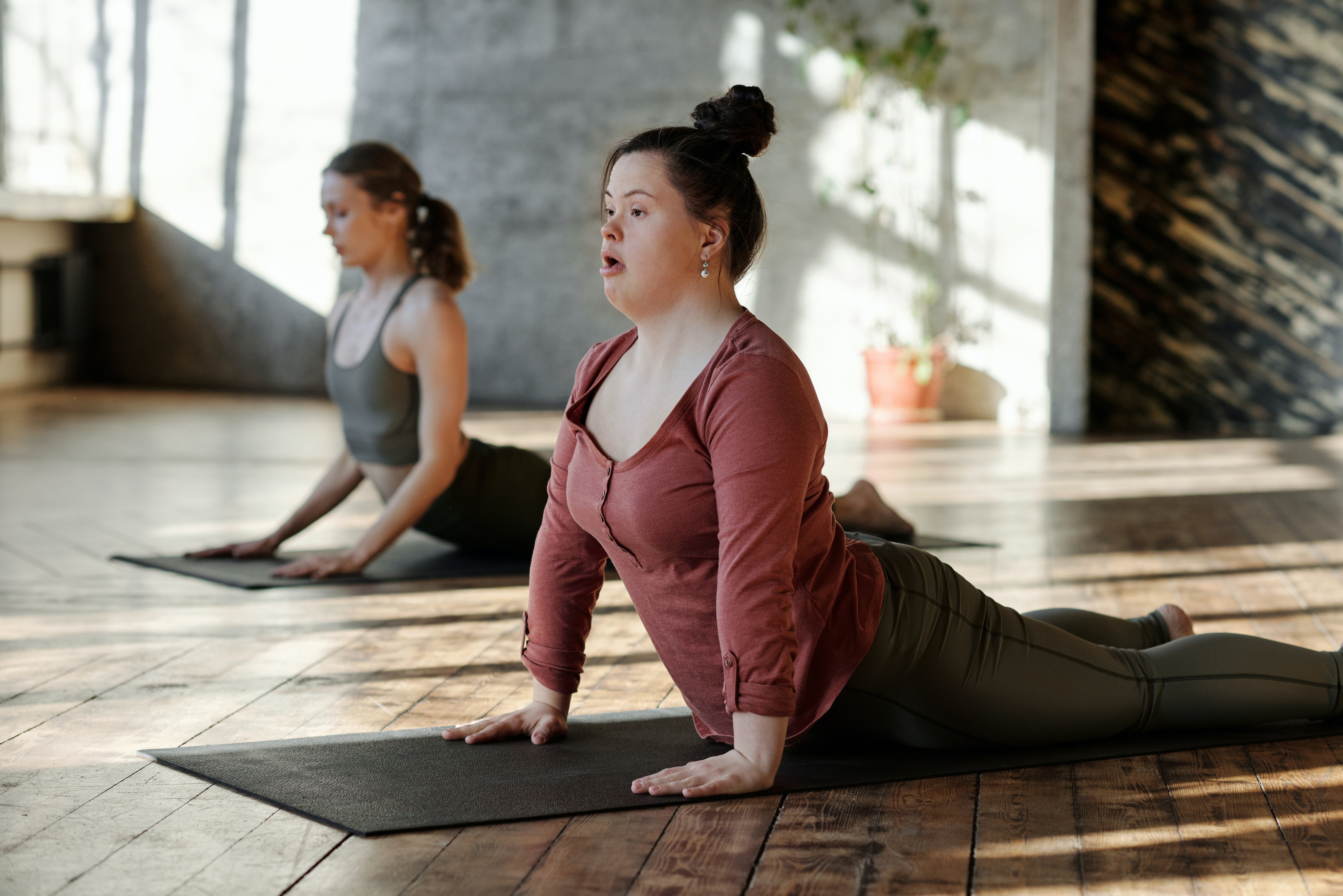 young person practiving yoga in studio