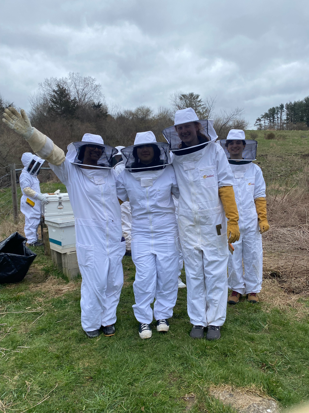 Photo of UConn Beekeeping members posing in their beesuits.