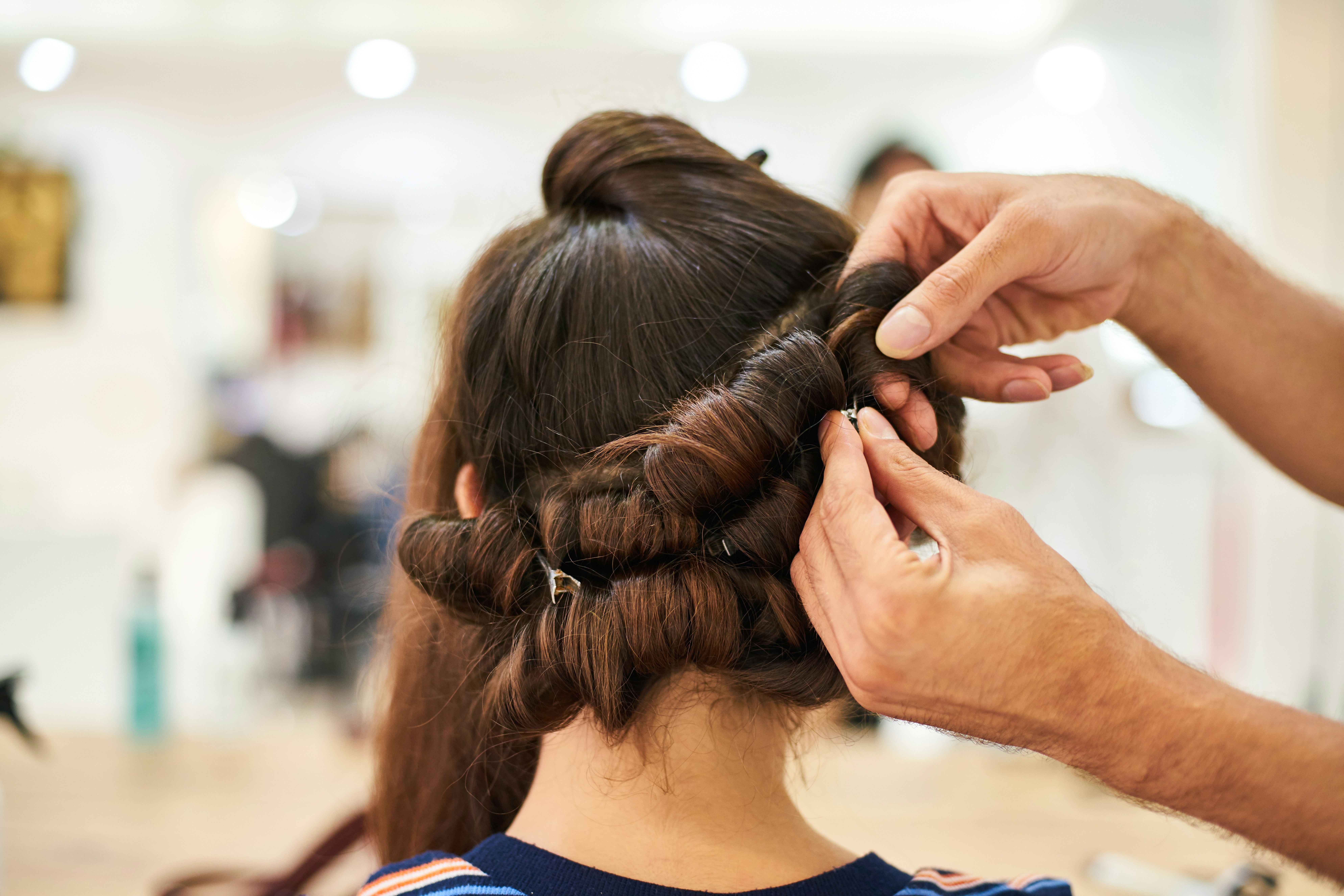 Hairdresser Making Hairstyle in a Beauty Salon