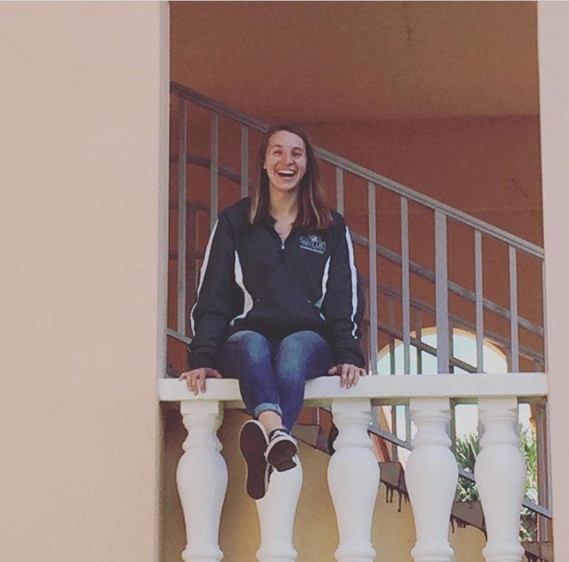 Woman sitting on banister