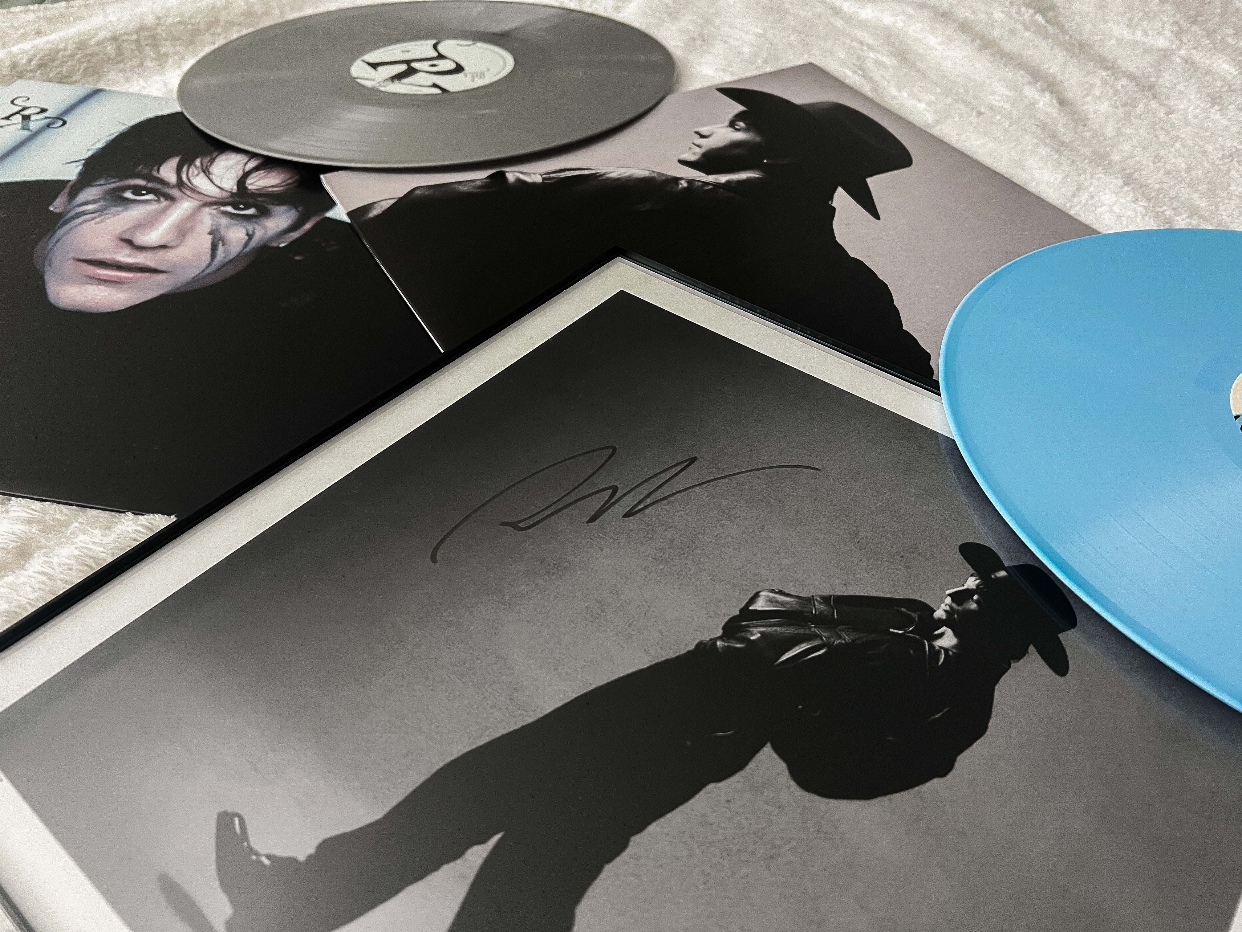 A collection of vinyls, including a signed poster of indie artist Role Model.