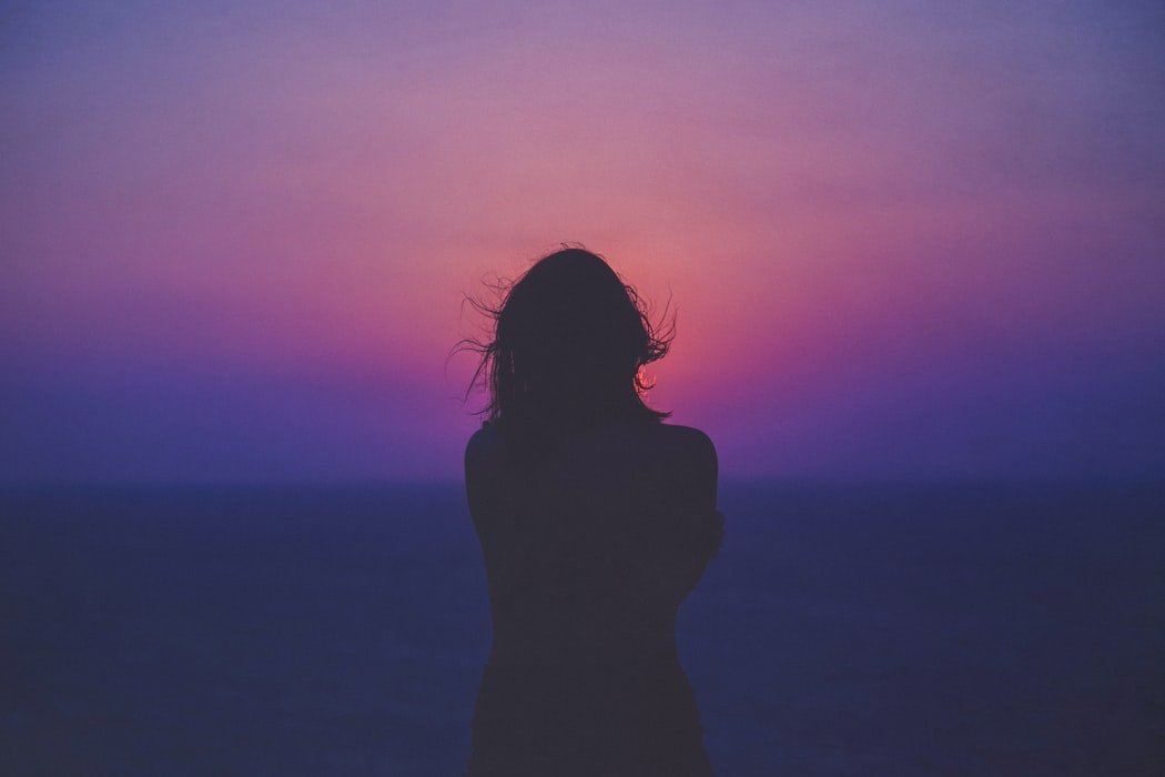 Girl in front of sunset