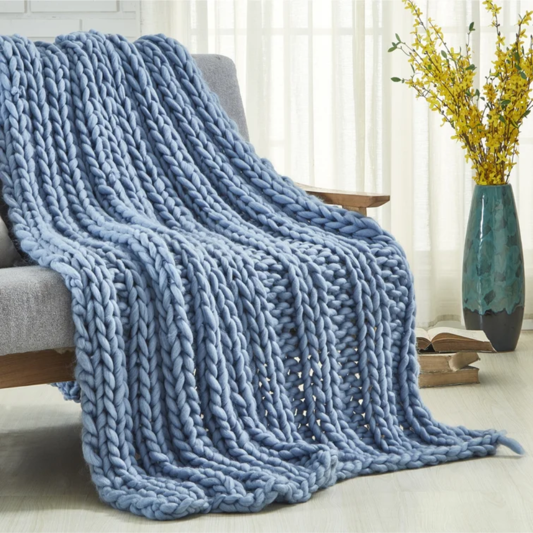 blue knit throw blanket draped over a couch