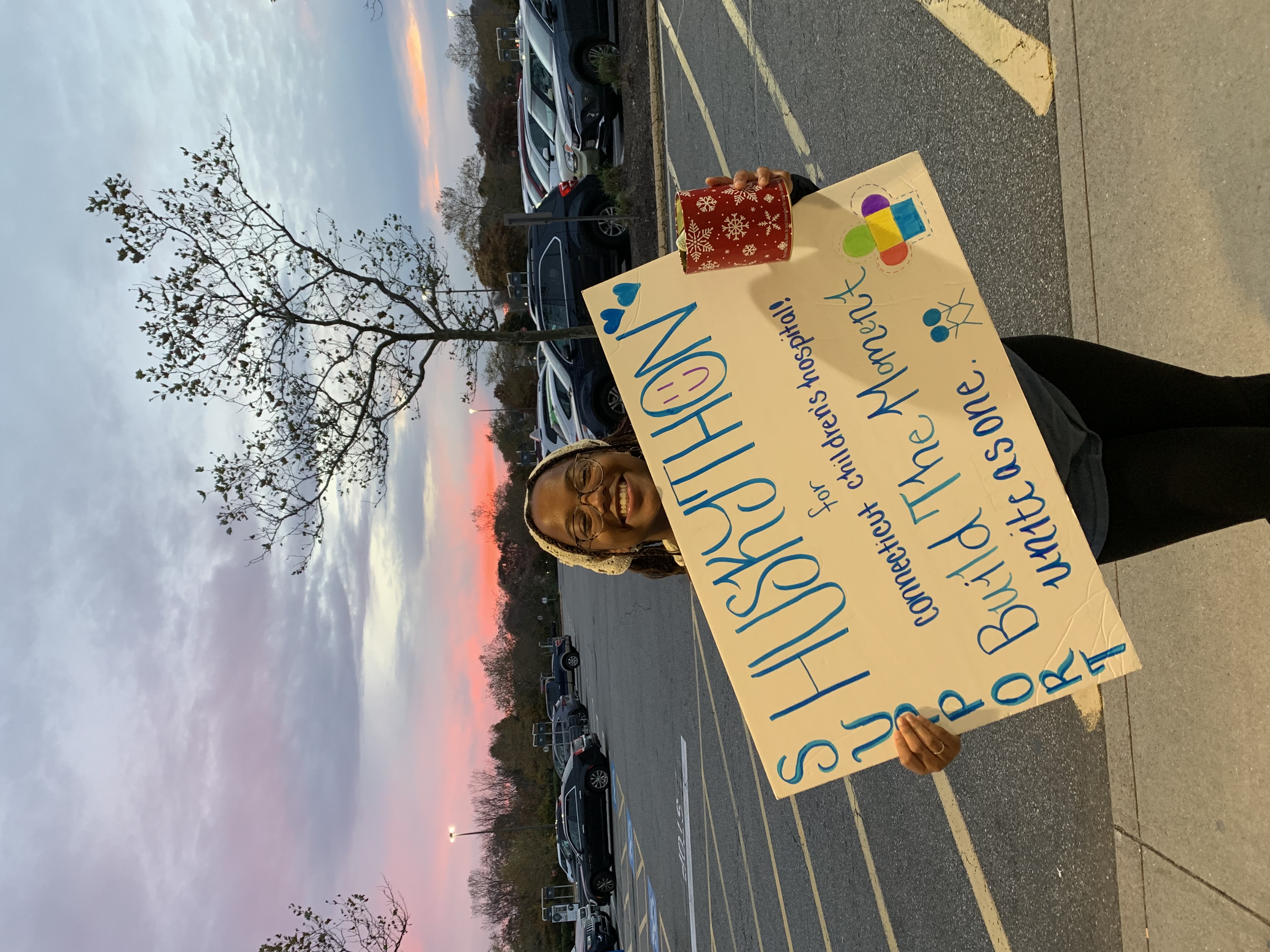 Girl Holding a Sign Supporting HuskyTHON