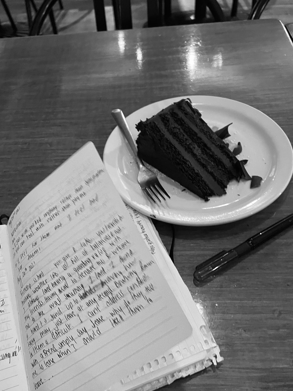 a journal with a slice of cake beside it