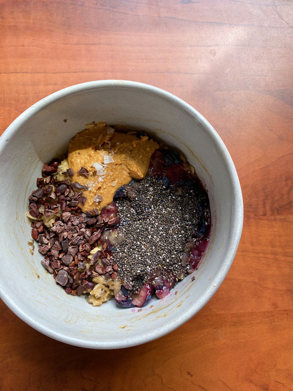 SImple dorm oatmeal with nut butter, chia seeds, and chocolate pieces