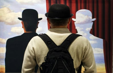 Men in a museum seeing an paint by magritte