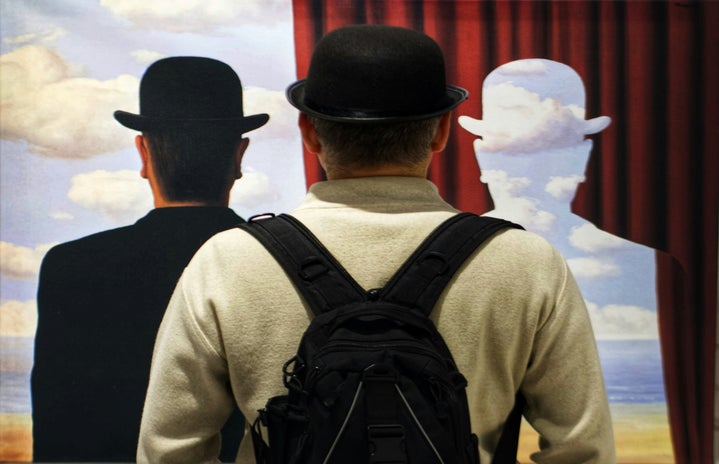 Men in a museum seeing an paint by magritte