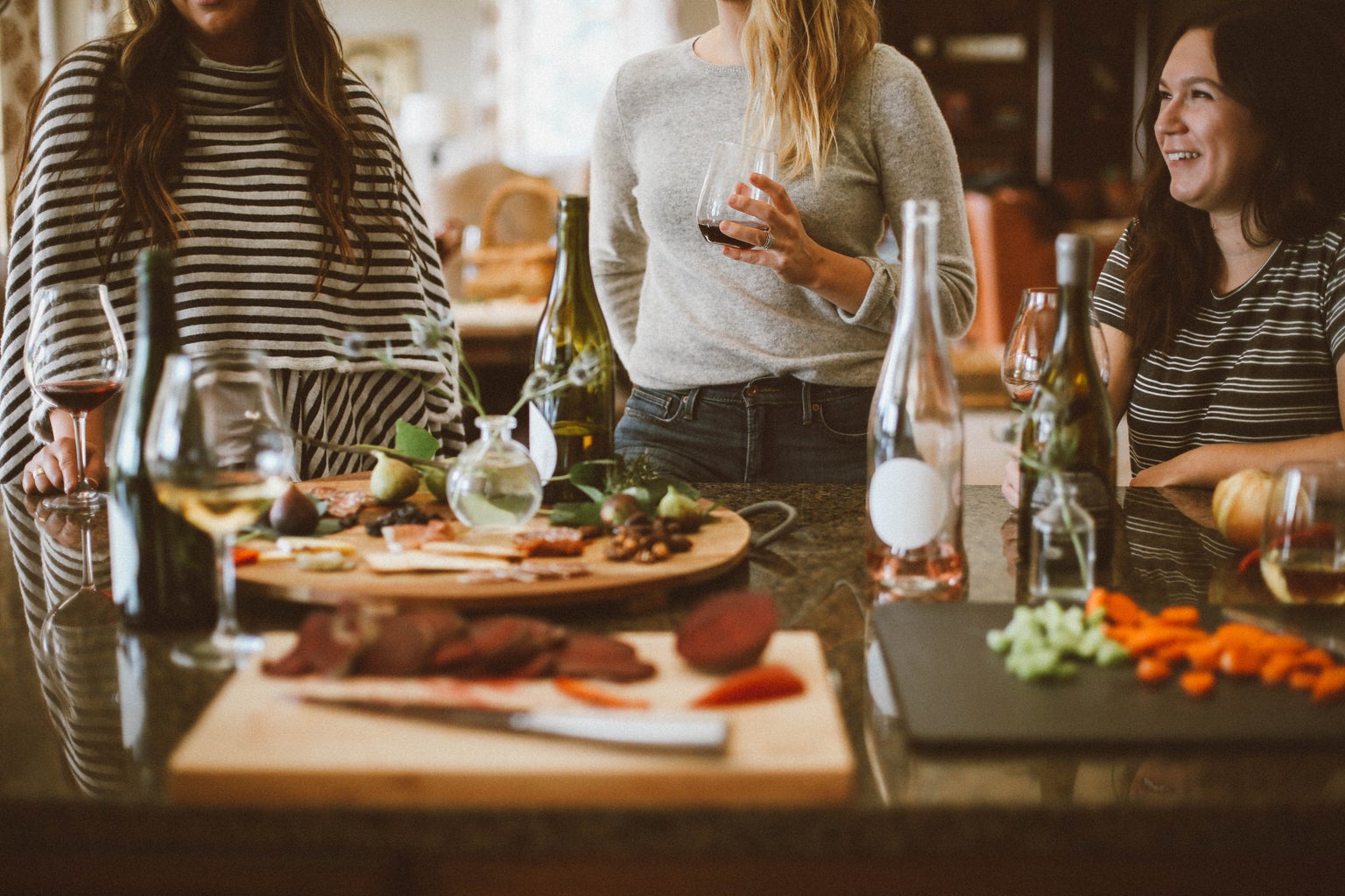 three women hosting a dinner party