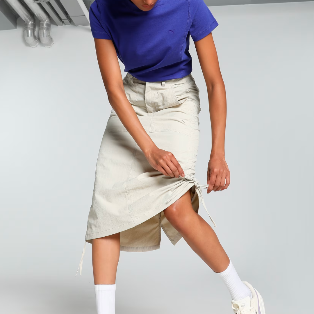 woman wearing a light khaki midi skirt and blue t-shirt