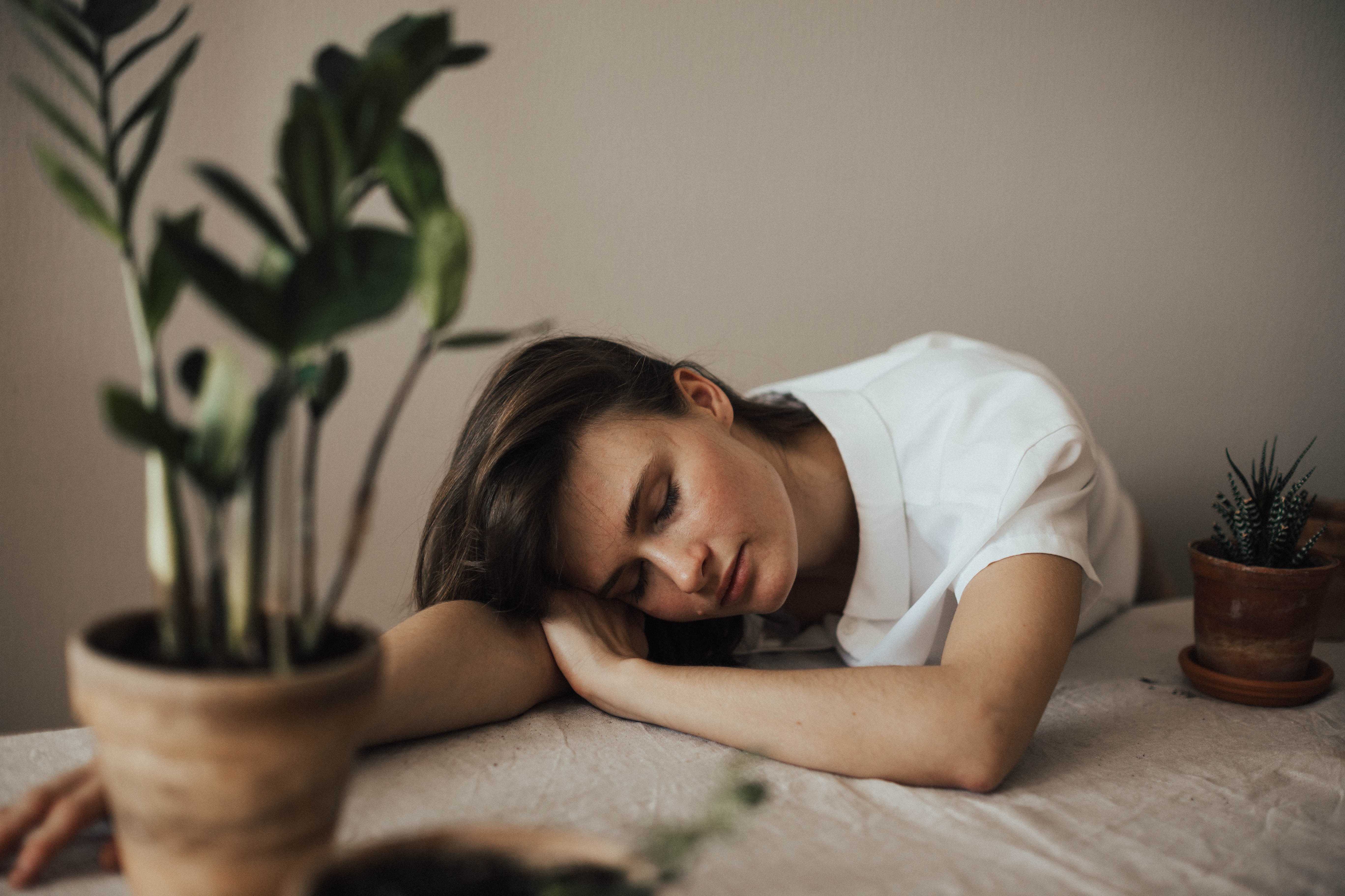 Sad woman resting her head on a table