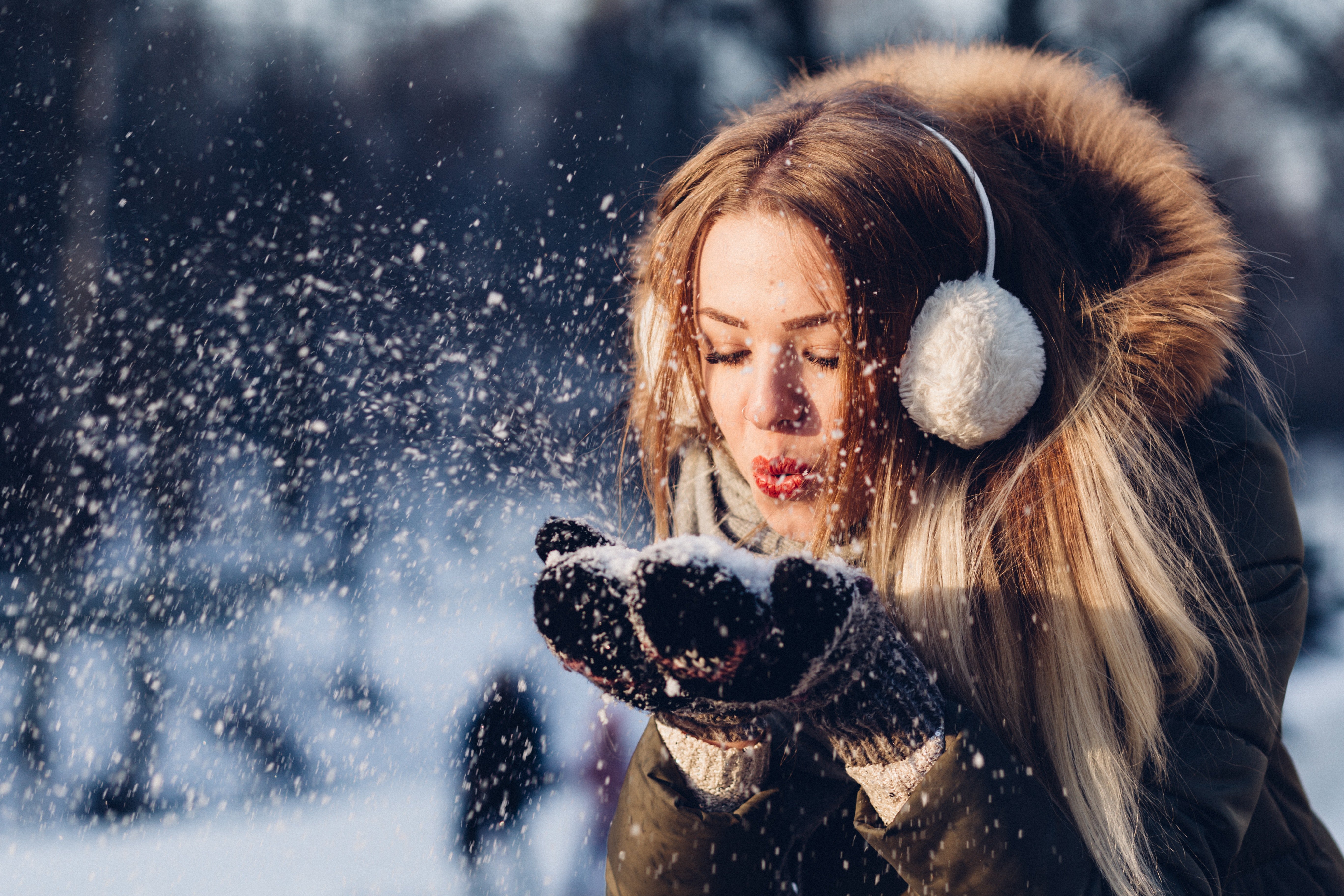 Girl blowing snowflakes