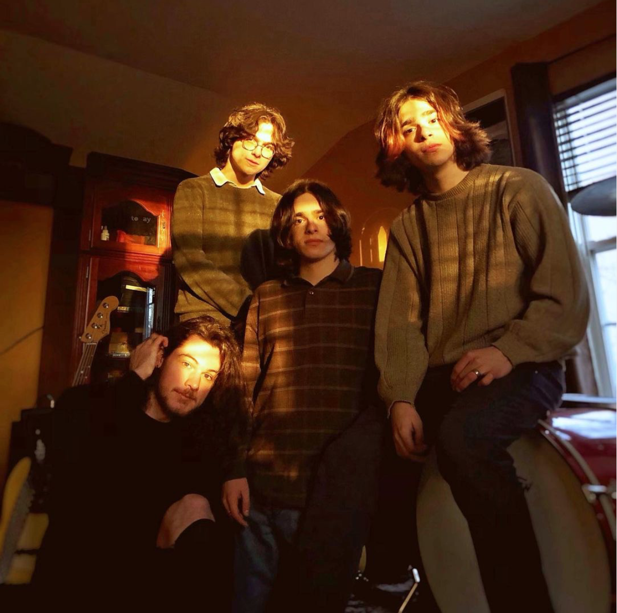 4 guys posing for a band photo