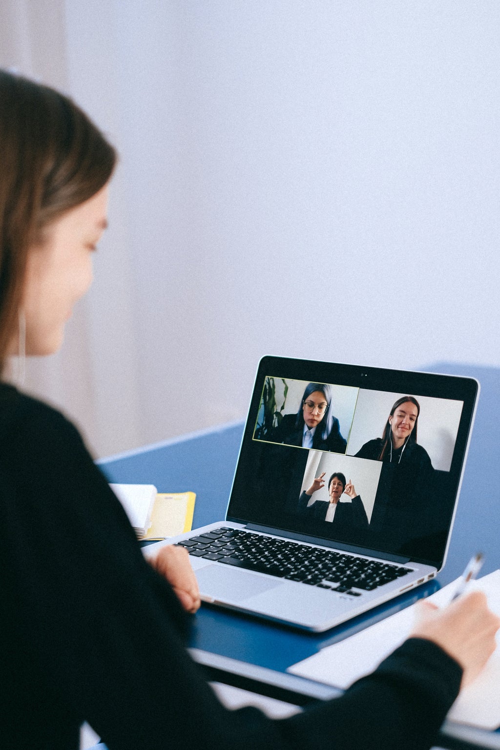 woman on a conference call with 3 others