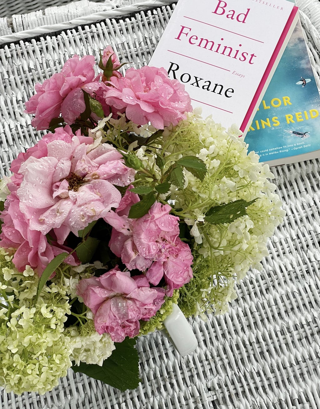flowers on a white table with two books