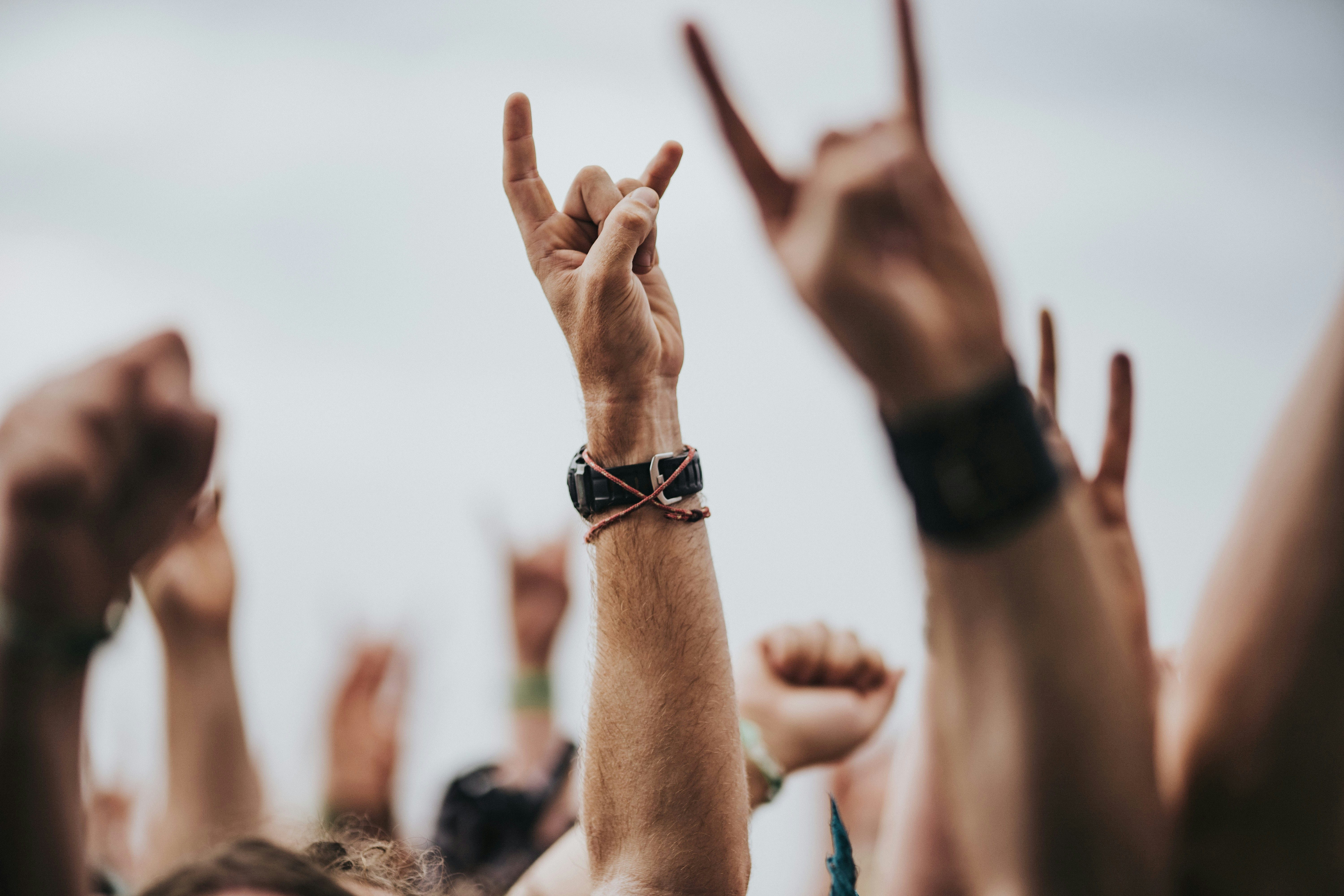 Person with hand in air at festival