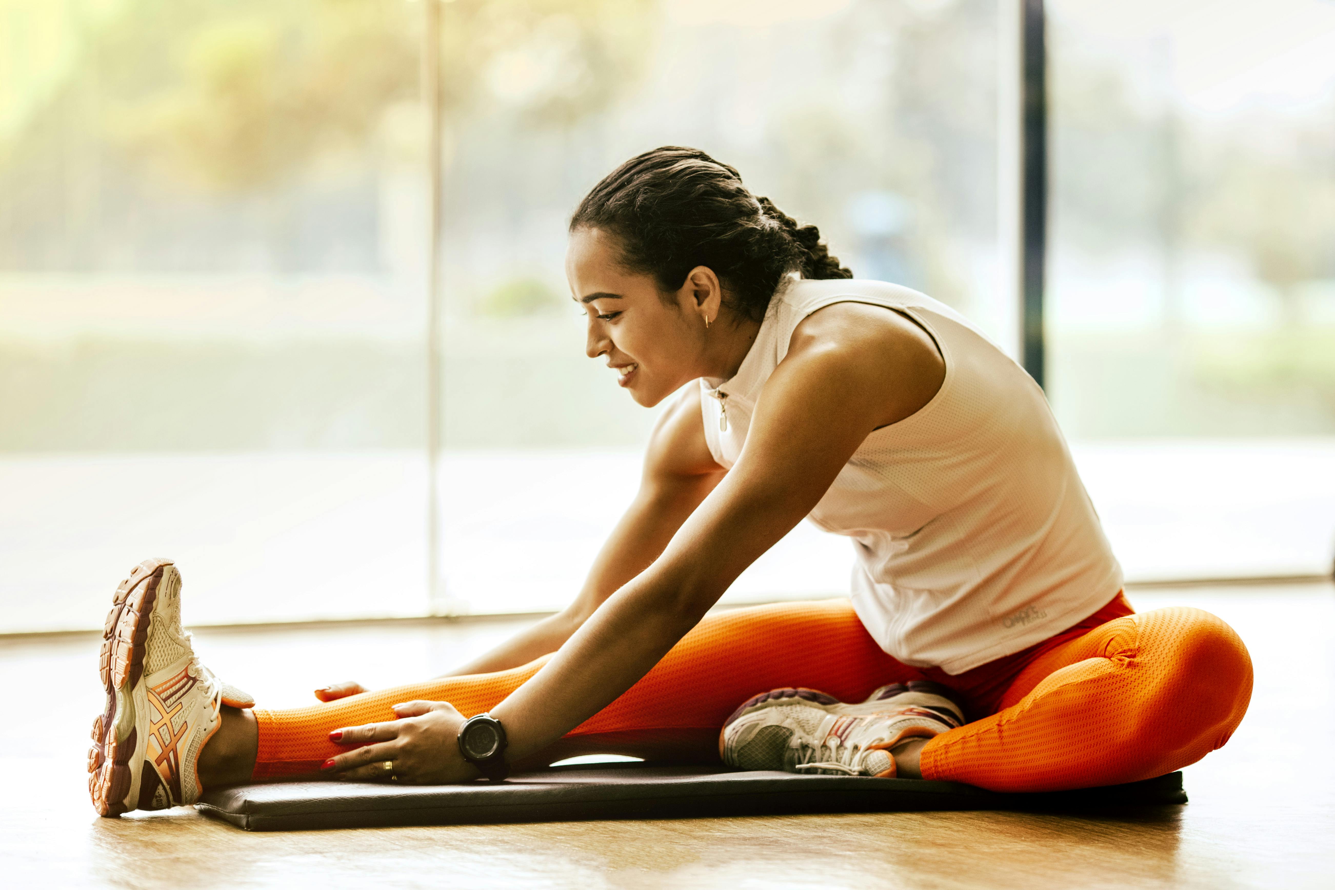 Woman at gym stretching