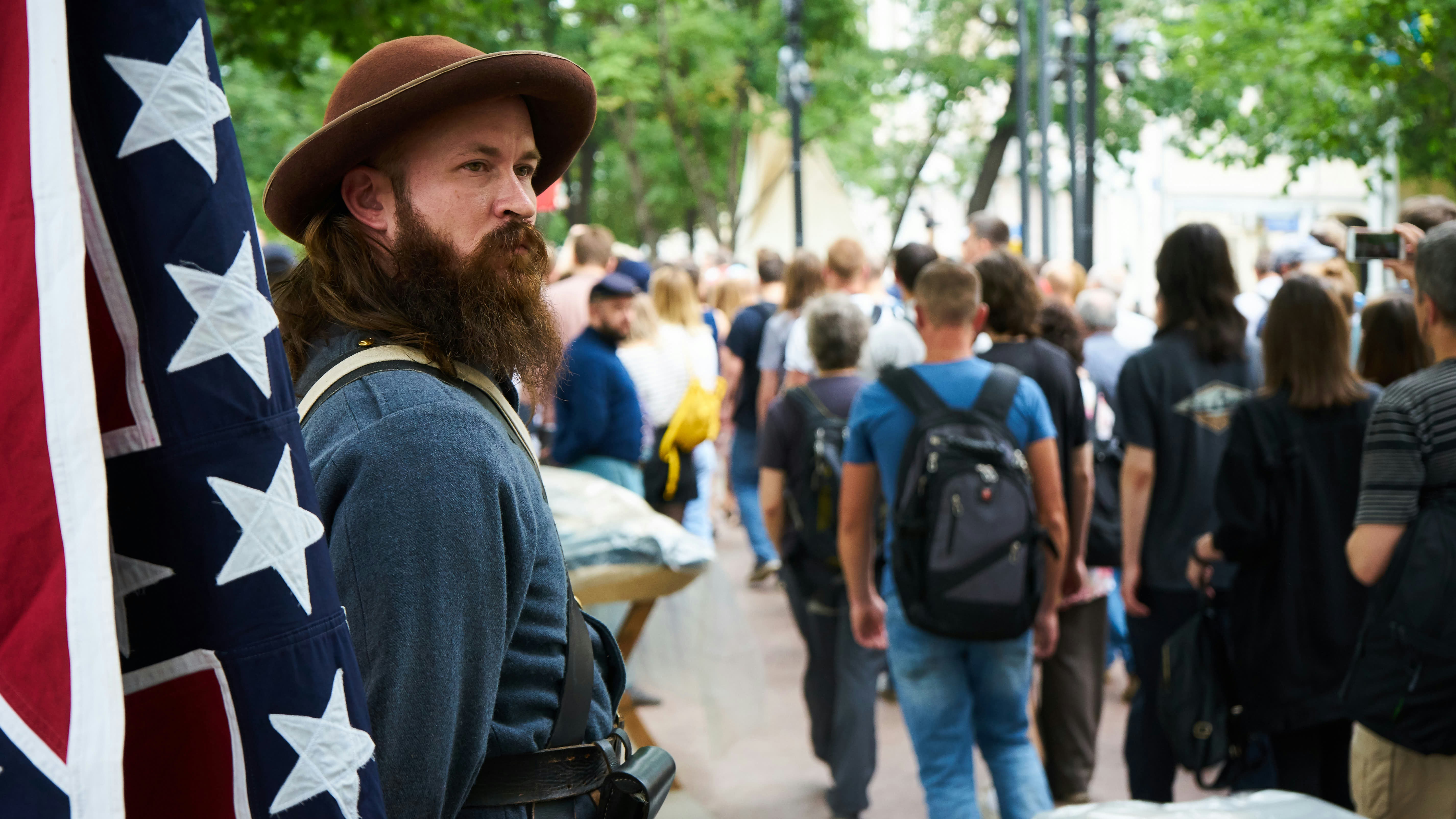 man holding a flag in public