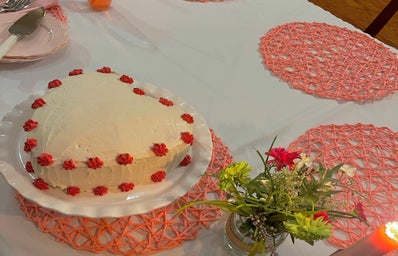valentines day party heart cake with flowers and candles on table