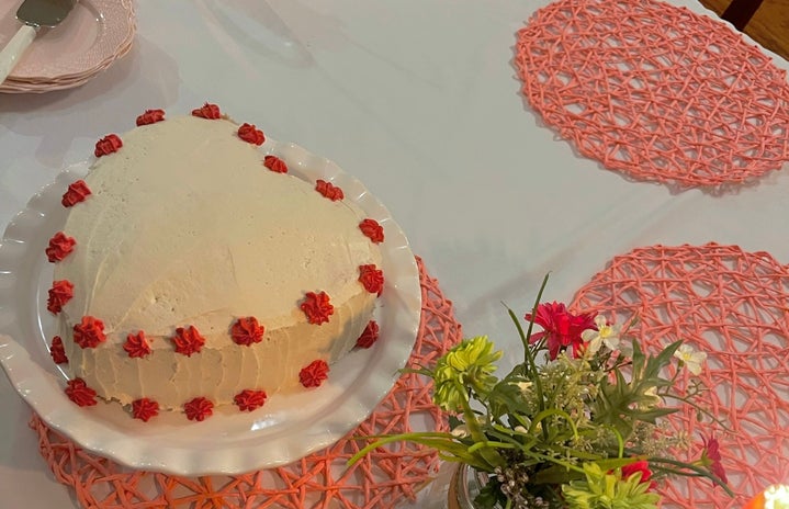 valentines day party heart cake with flowers and candles on table