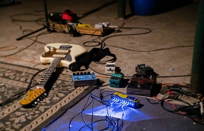 White electric guitar on blue guitar amplifier