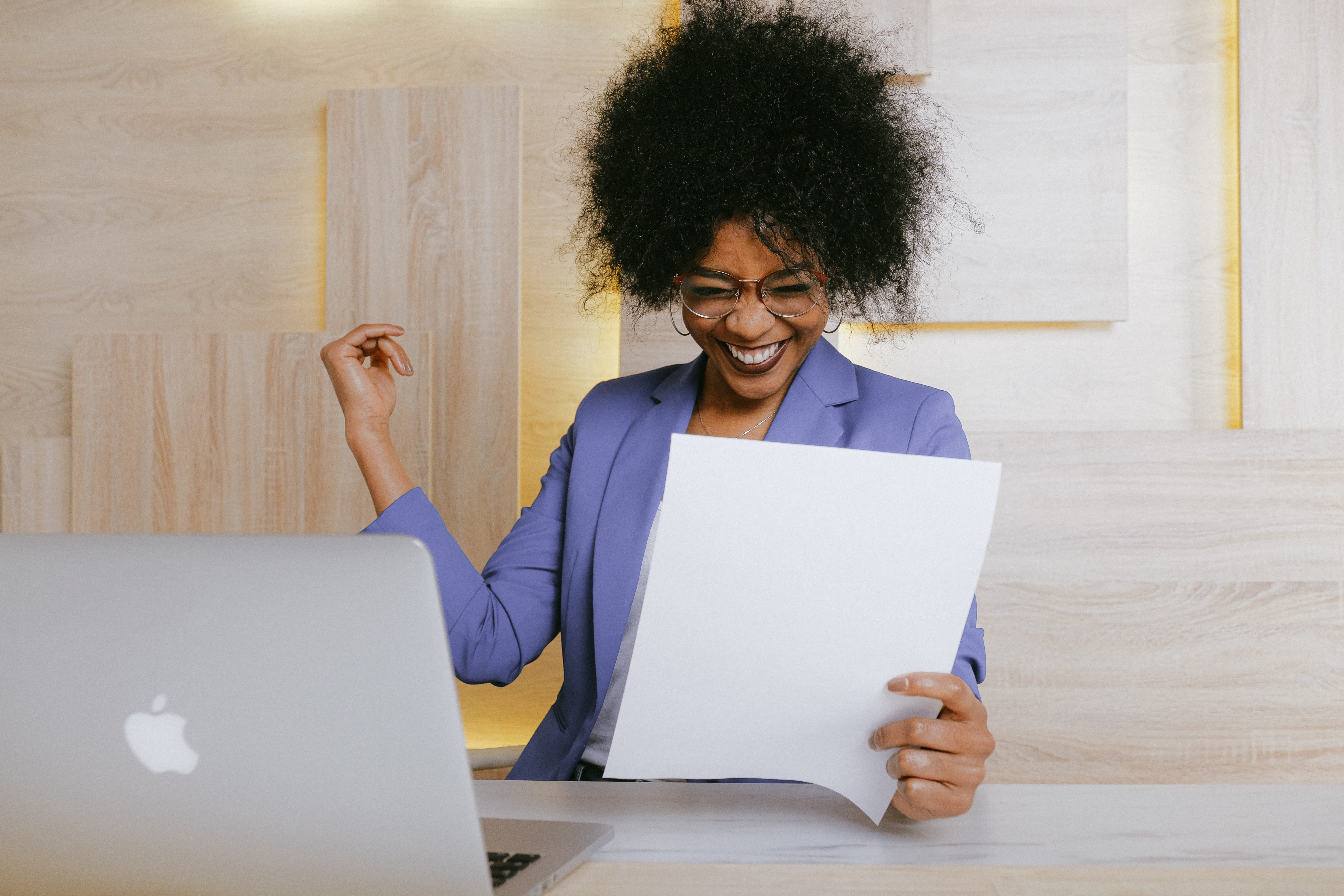 woman holding a paper looking happy
