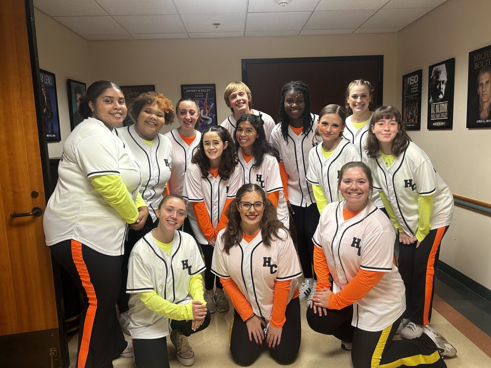 hiphop dance group posing in neon outfits