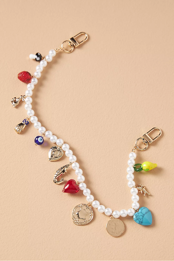 A pearl bag chain on a tan background