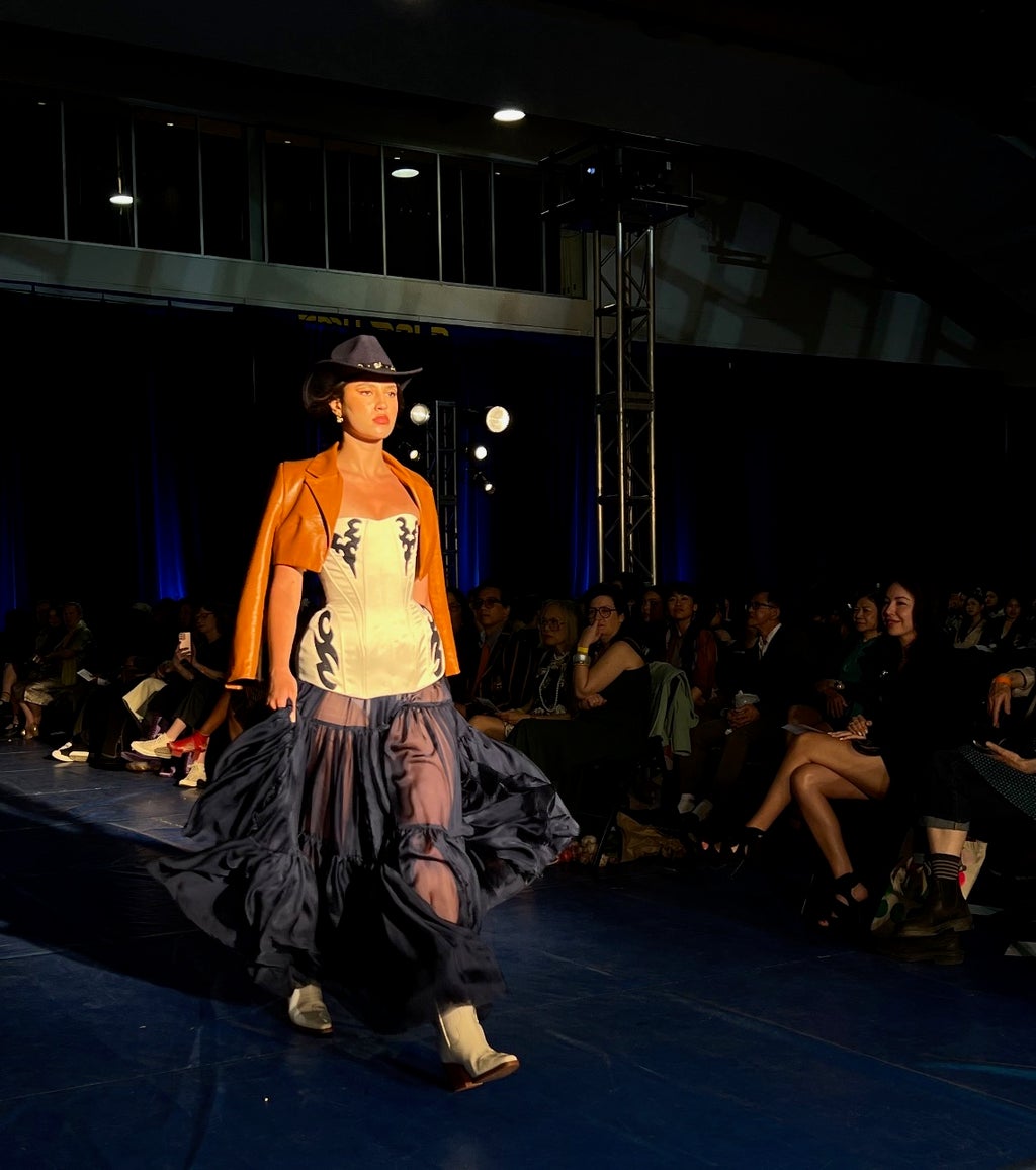 Model showcasing Mikaila Taliana\'s designs on the runway.