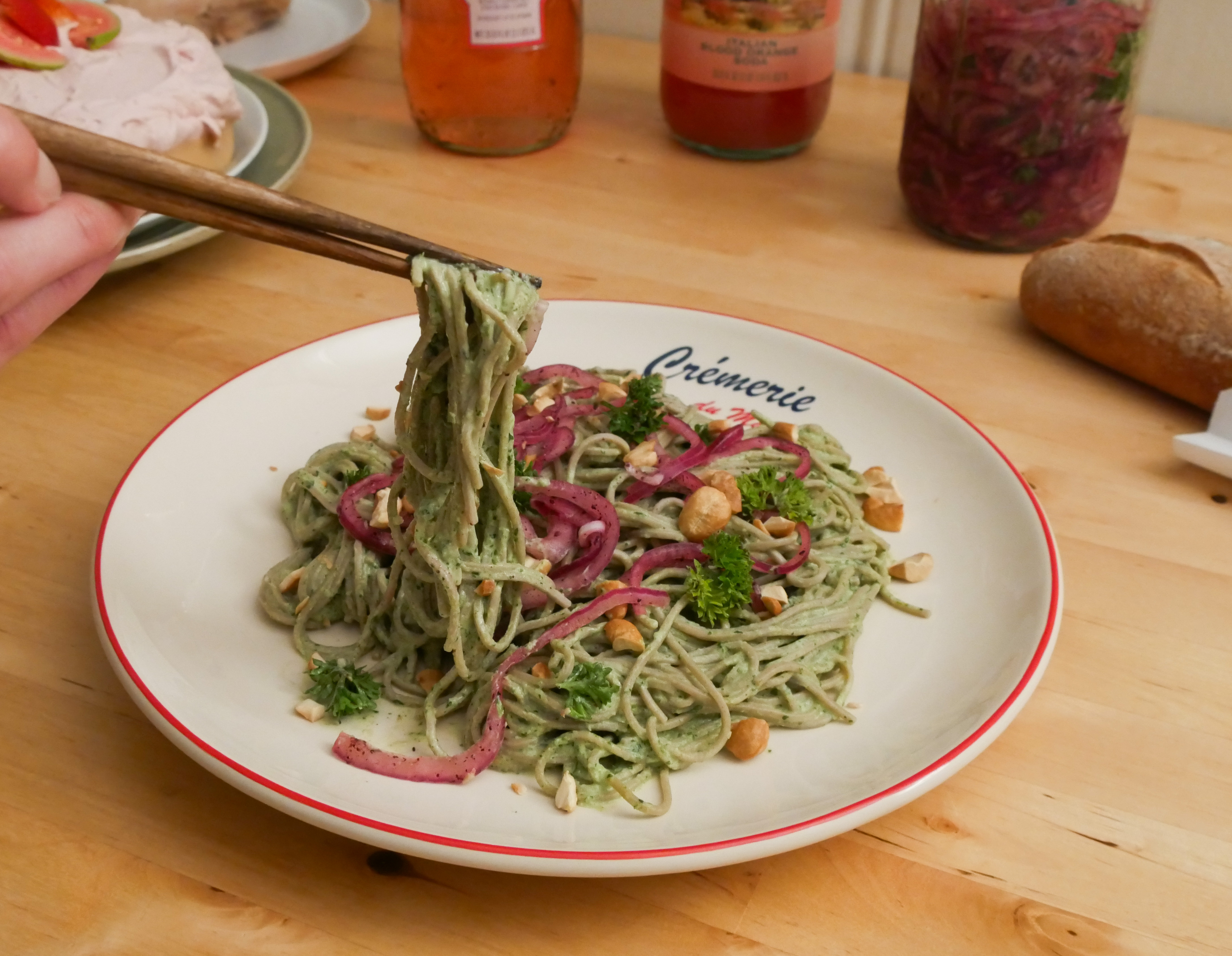 Person holding noodles with chopsticks.