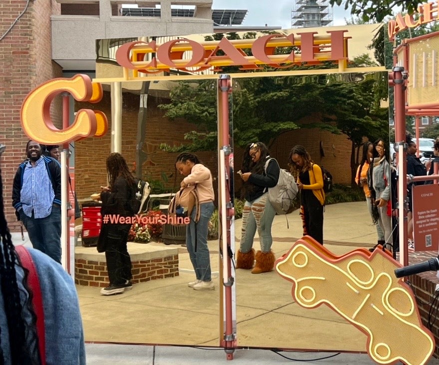 Howard students stand in line to receive free drinks at Coach pop up event.