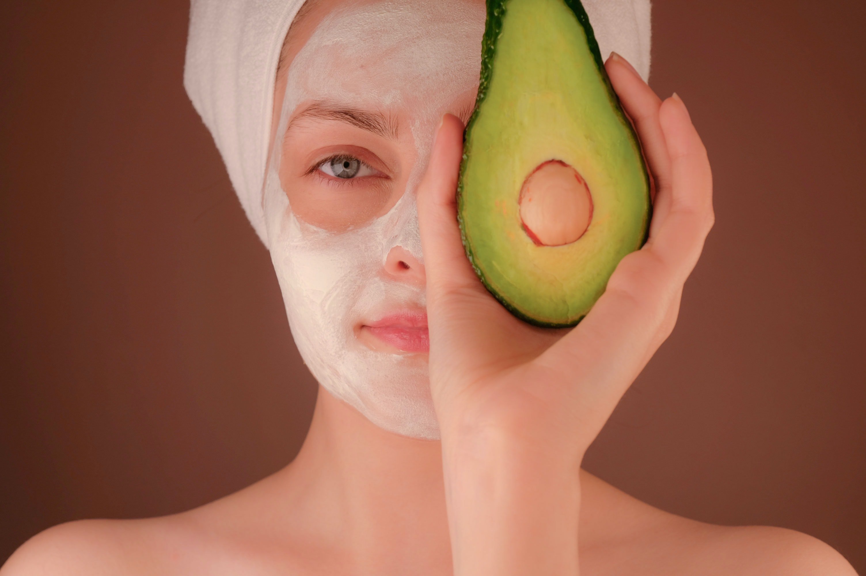 woman holding avocado