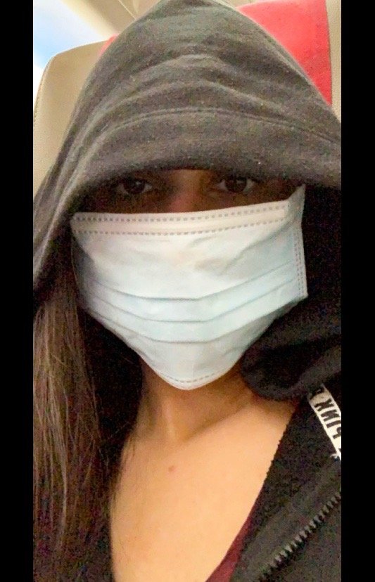 Picture of me on a flight with a mask on.