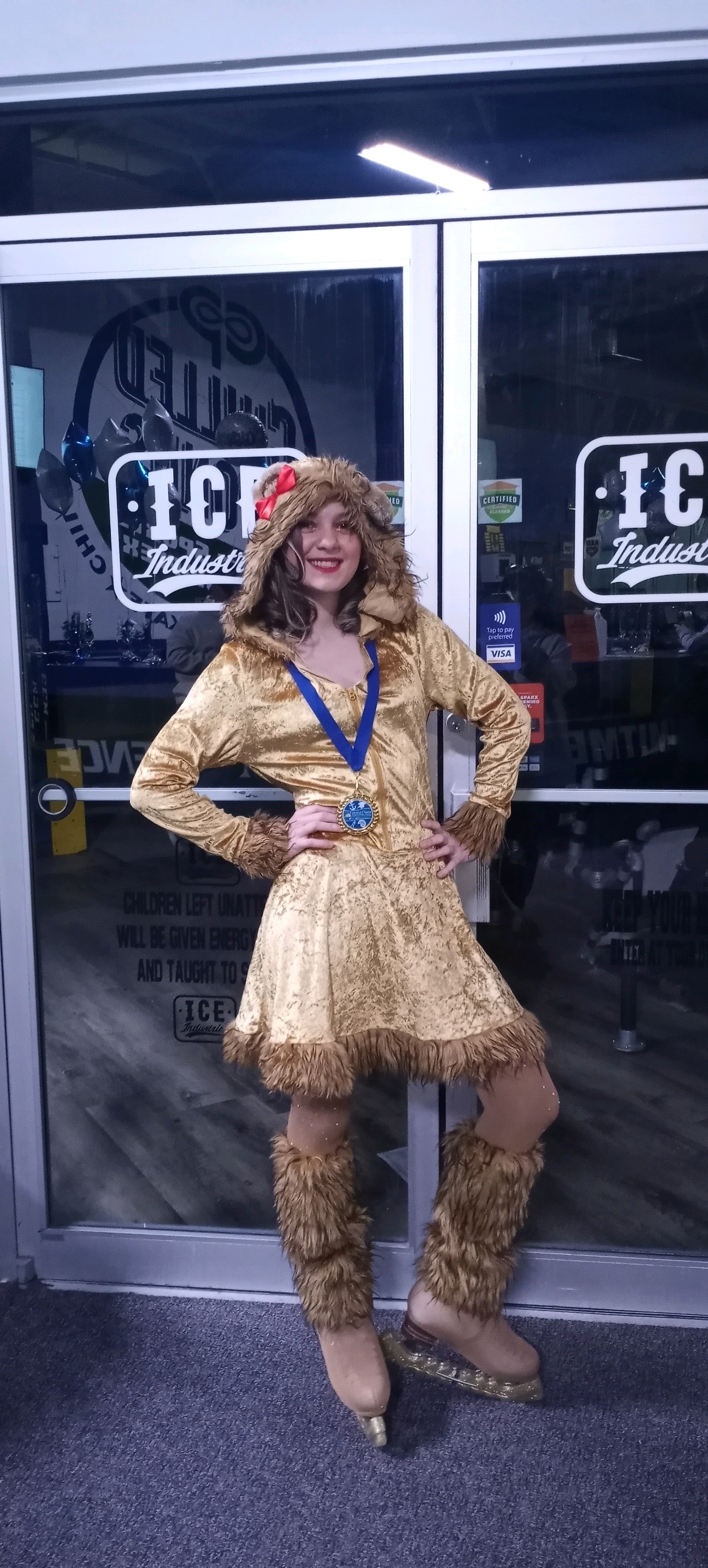 A figure skater wearing a lion costume